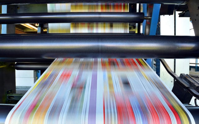 Printing machine with streaks of vibrant colors.
