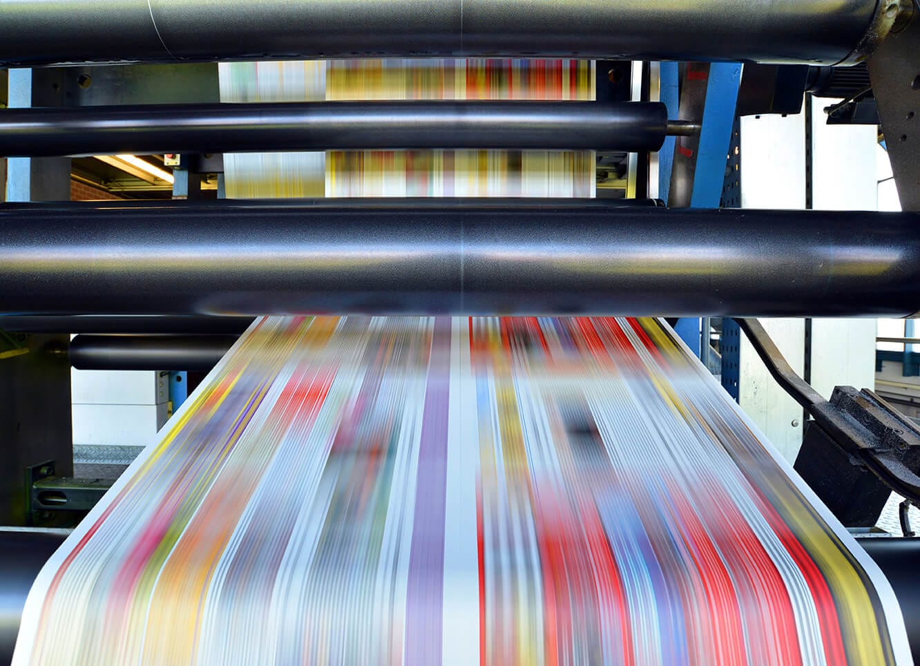 Printing machine with streaks of vibrant colors.