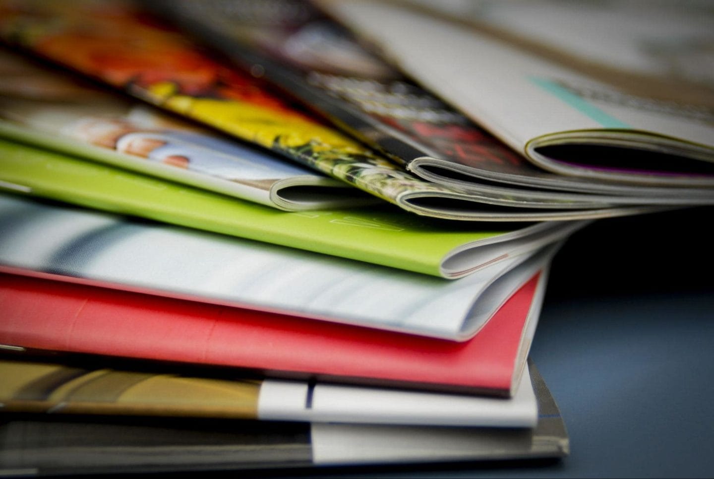 A set of colorful printed magazines assorted on a table.
