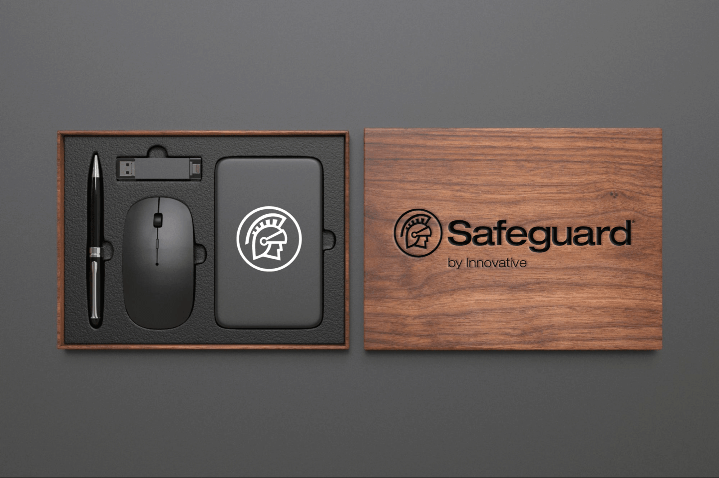 A wooden box with the Safeguard by Innovative logo on it holds a computer mouse, USB, pen, and power bank.