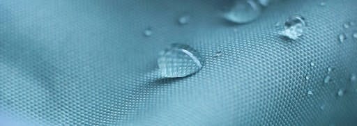 A piece of weatherproof material with water droplets unable to permeate its surface. 