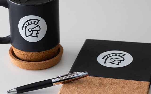 A safeguard-branded mug, pen, and notebook.