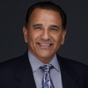 Headshot of a business person smiling on a grey background